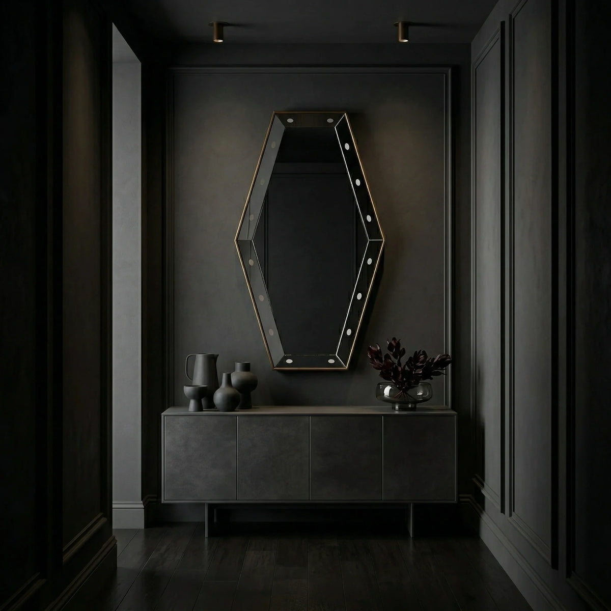Ambella Home Key Hole Mirror in antique gold, 30W x 5D x 54H faceted geometric wall mirror above a dark wood credenza in a moody luxury hallway
