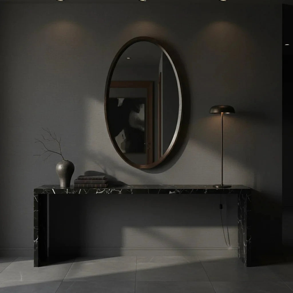 Modern interior with a round mirror, console table, and floor lamp against a dark wall.