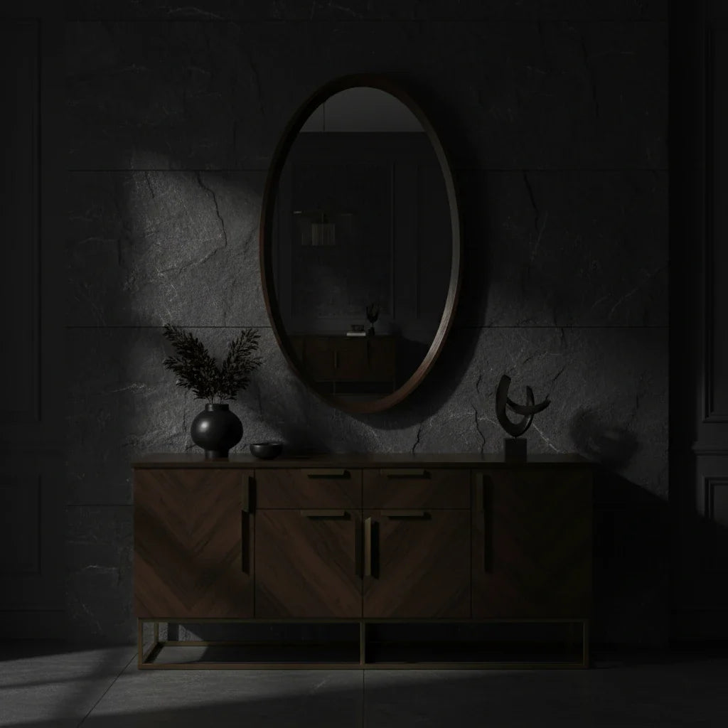 Dark room with wooden cabinet and oval mirror on stone wall