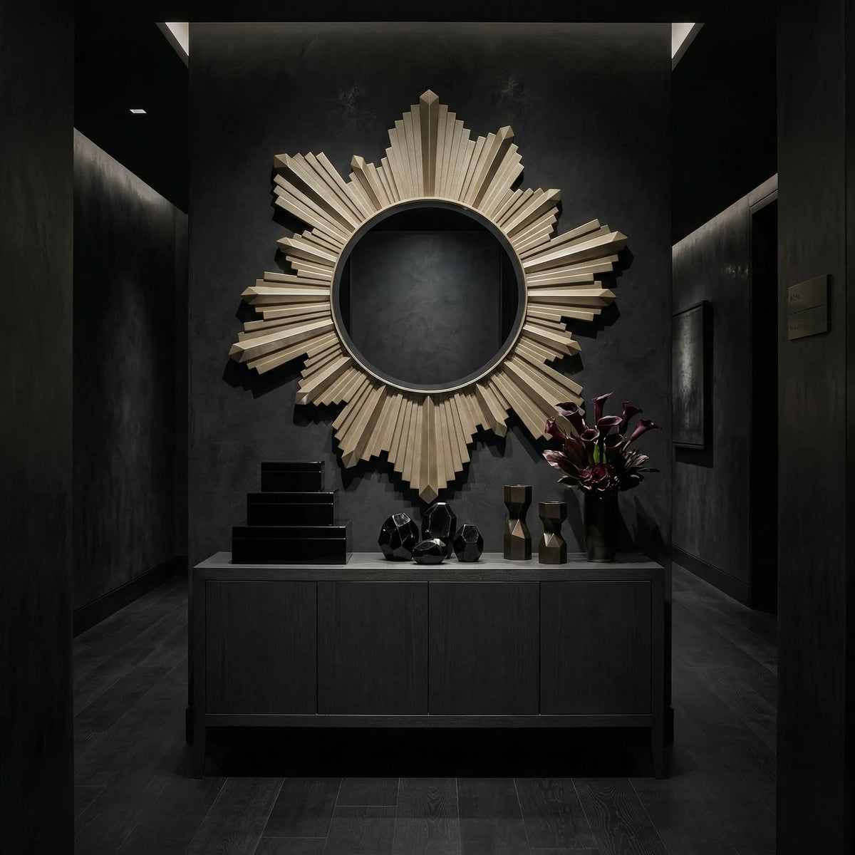 Round center Vassar Mirror by Ambella Home with champagne finish and stepped sunburst frame, displayed above a dark console in an elegant entry hall