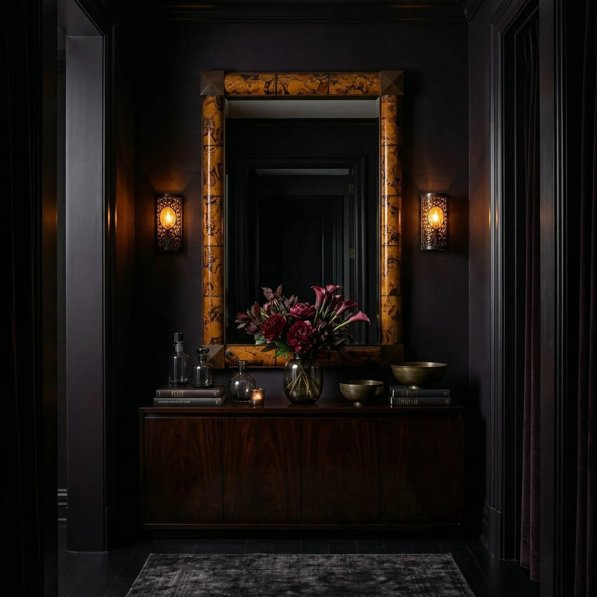 Ambella Home Delancy tortoise shell wall mirror, 38W x 3D x 56H, displayed above a mahogany credenza with florals in a dark luxury interior