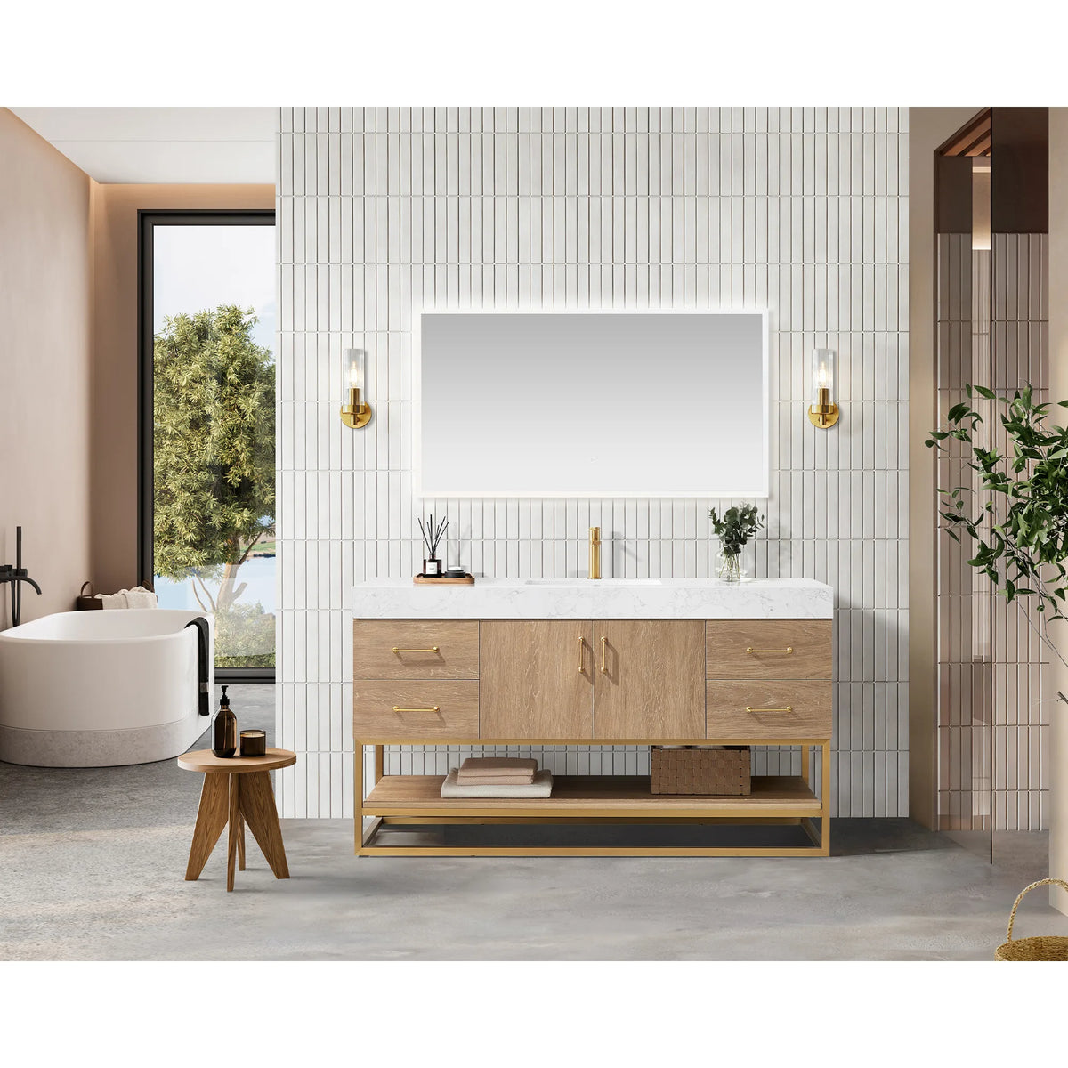 Room scene with a 60 inch single vanity, wall mirror and gold sconces, soaking tub, wood stool and tiled wall