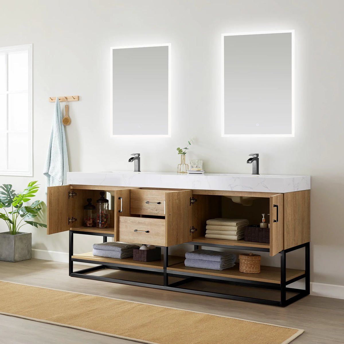 Room view of the double vanity with the left door open and a drawer extended over towels and jars, two mirrors above