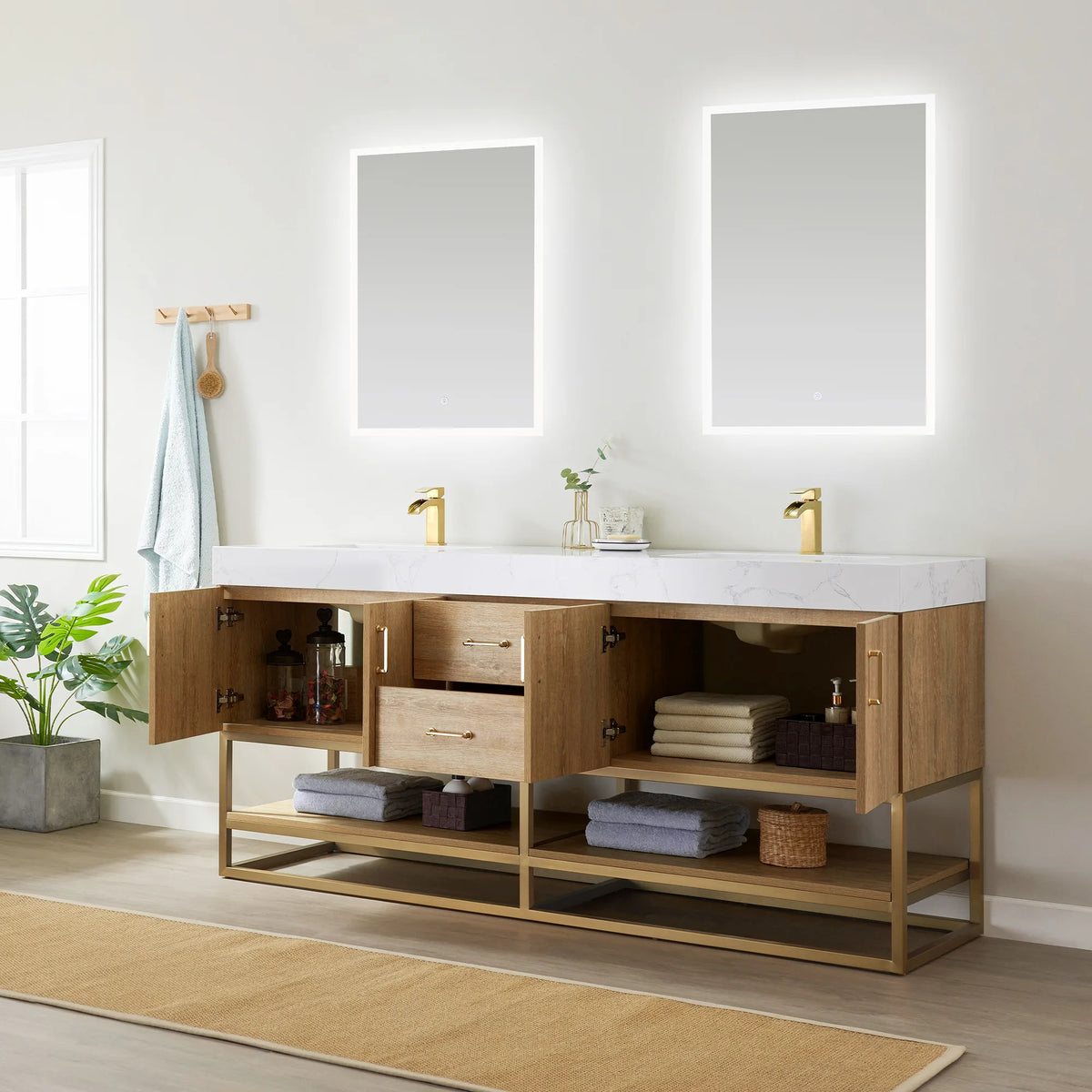 Room view of the double vanity with doors open and a drawer extended over towels and jars, a rug at the base