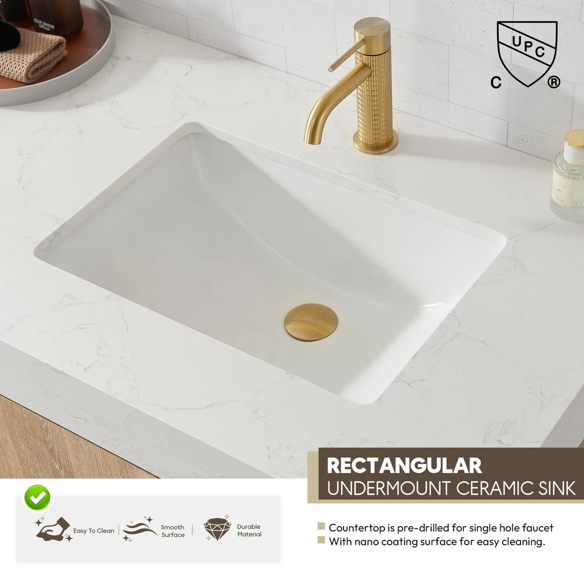 Close-up of the rectangular undermount ceramic sink in the white grain stone top, gold drain