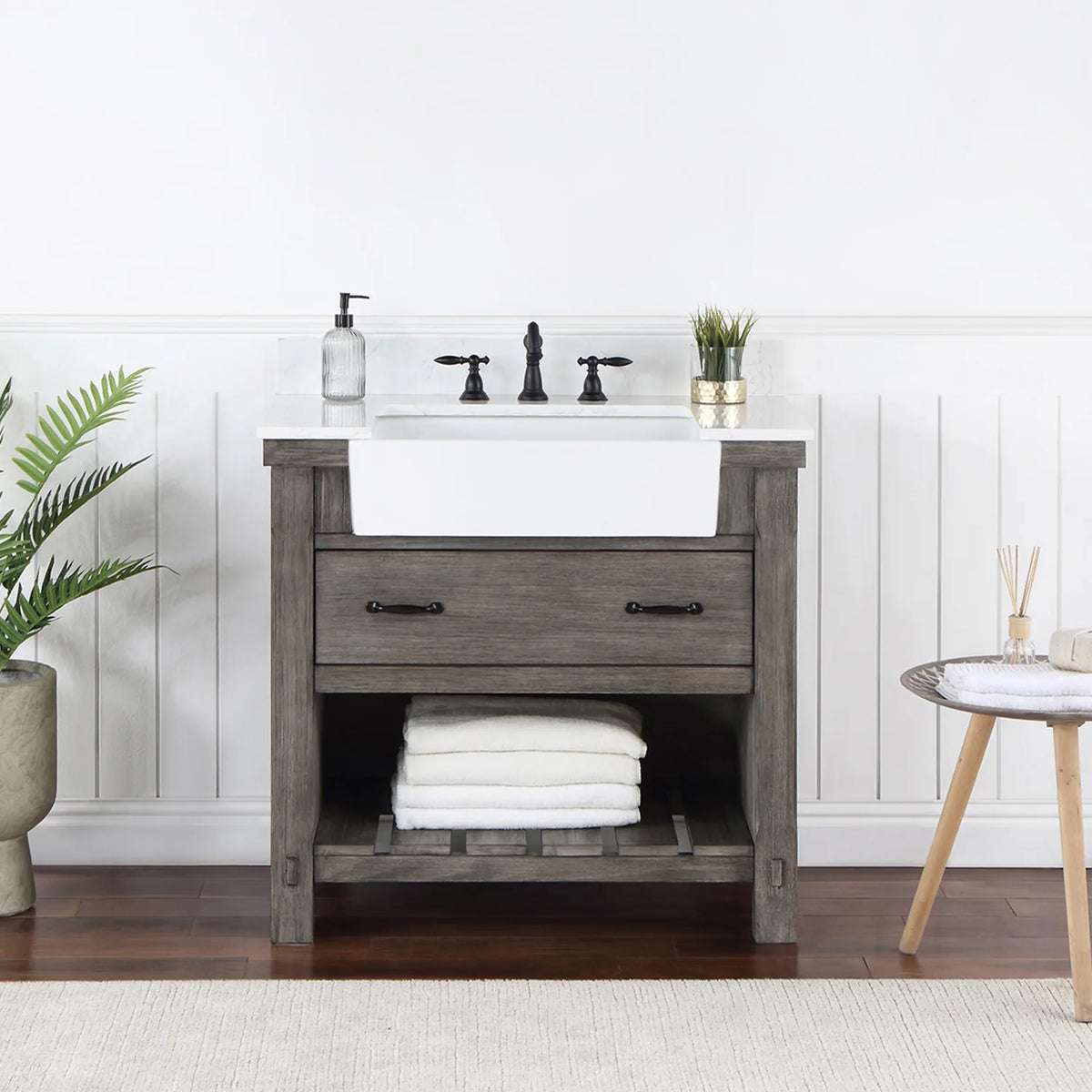 Bathroom setting with white paneled wall, fern and side table beside the vanity