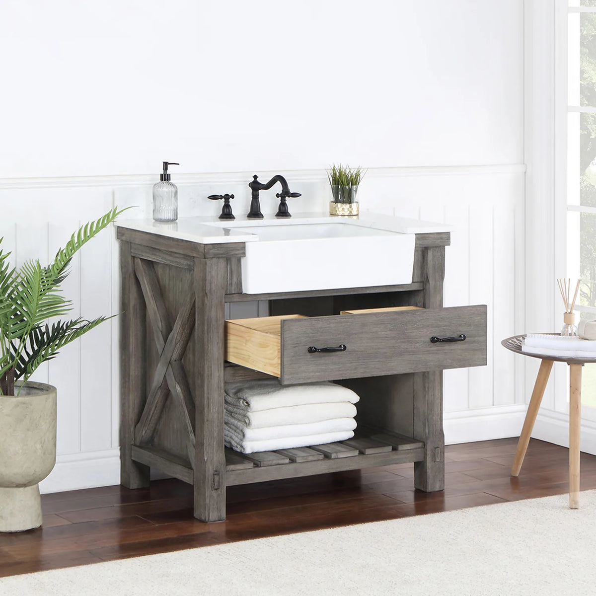Single drawer open at an angle, X-brace side and open shelving with towels in view