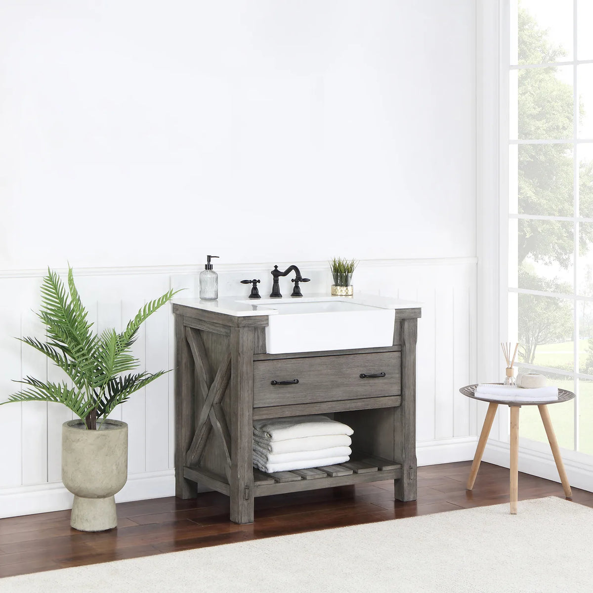 Vanity seen from a distance at an angle, window light and plant beside it