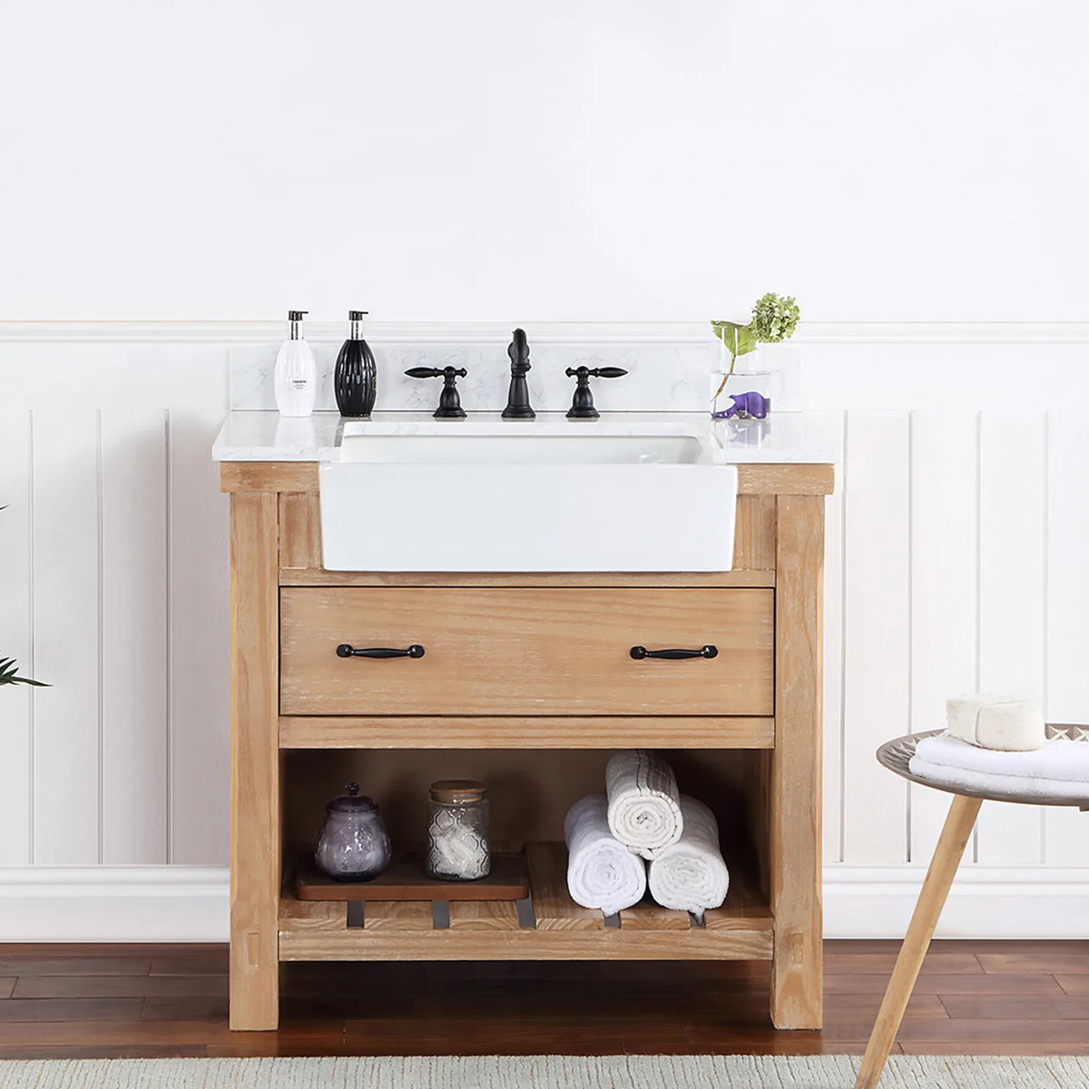 Bathroom setting with white paneled wall, fern and side table beside the vanity