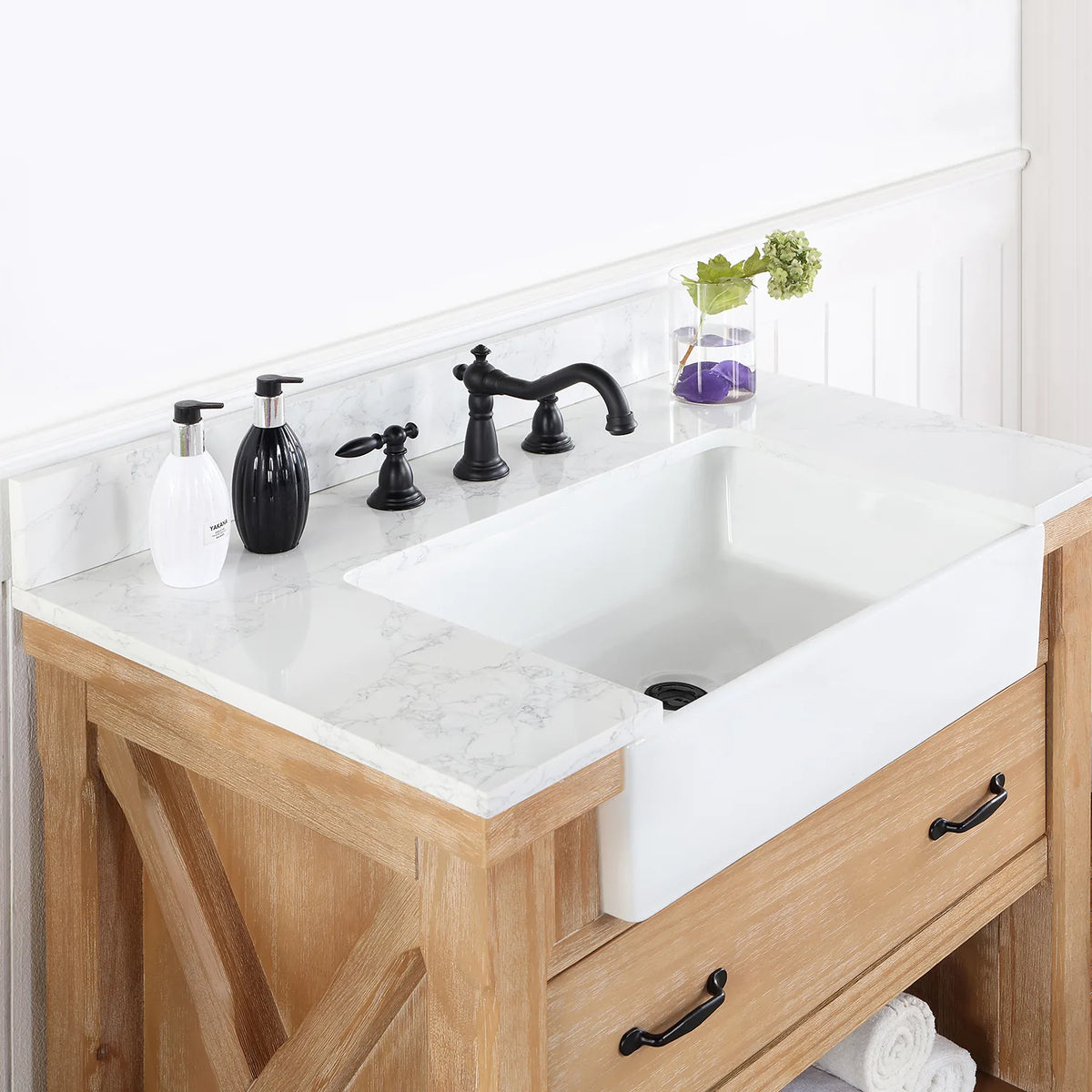 Angle across the white basin and backsplash with a black widespread faucet (sold separately)