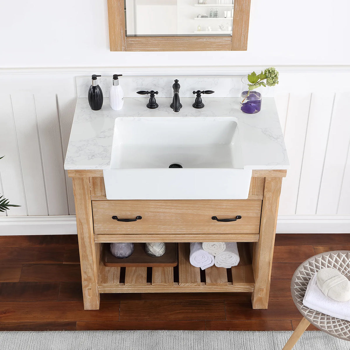 Stone top and white basin in a tighter crop, matte black pulls on the drawer front below