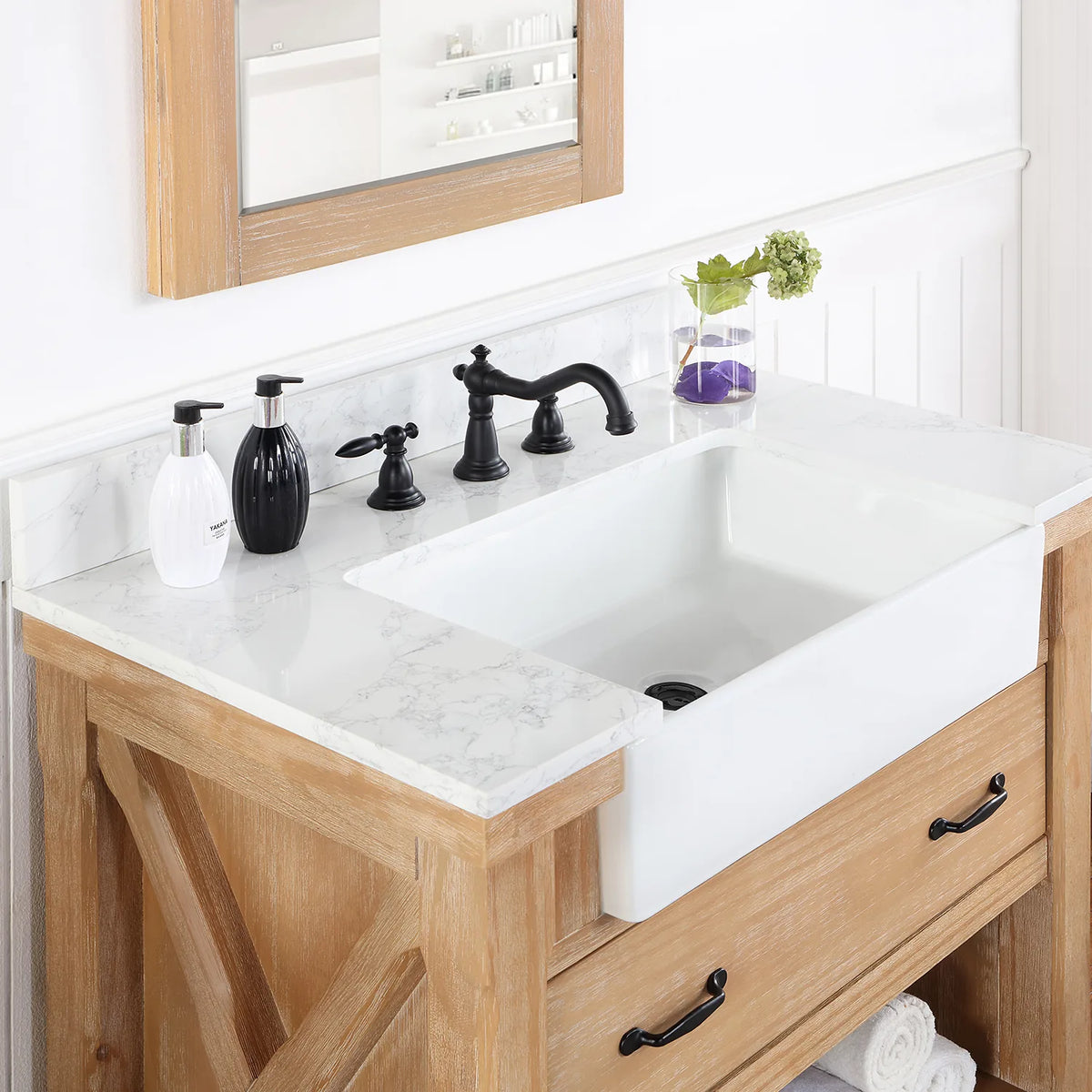 Deep white basin set into the stone top, seen from the side with the faucet