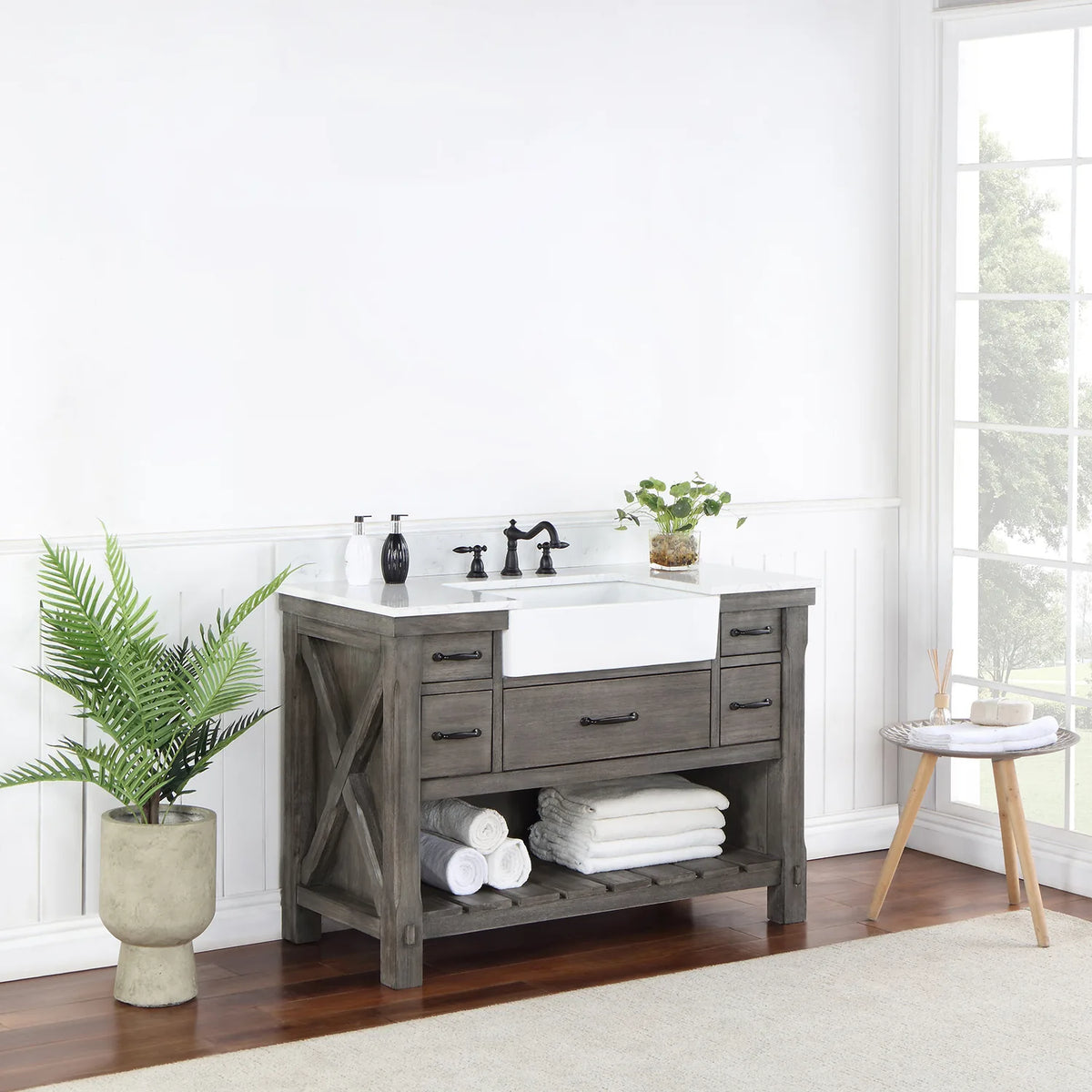 Vanity seen from a distance at an angle, window light and plant beside it