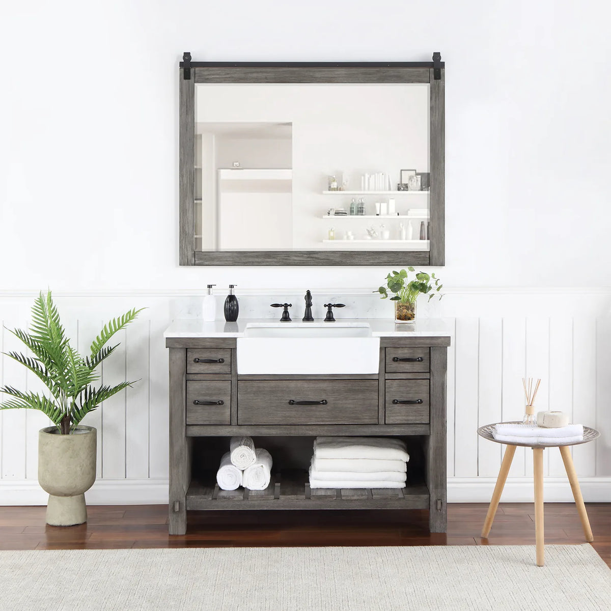 Rectangular mirror with sliding-rail hardware hung over the vanity in a styled room
