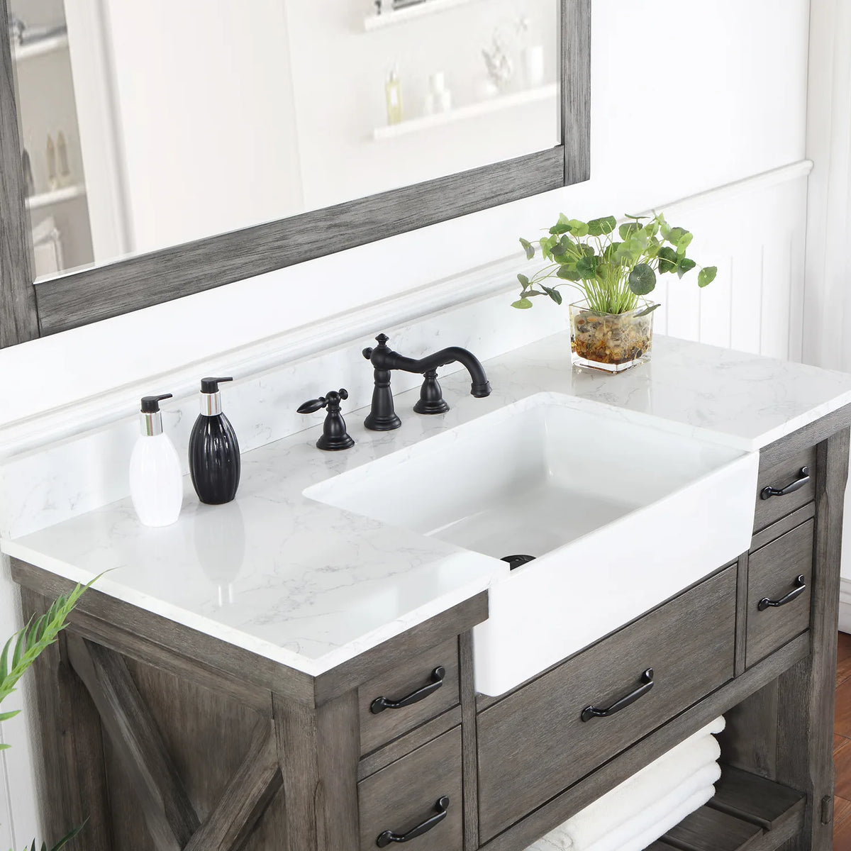 Deep white basin set into the stone top, seen from the side with the faucet