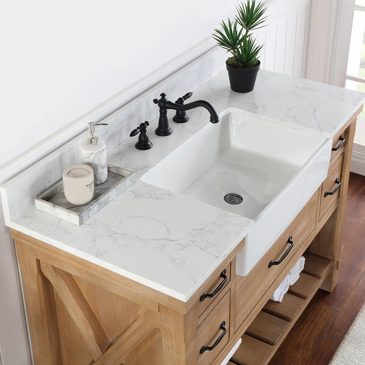 Angle across the white basin and backsplash with a black widespread faucet (sold separately)