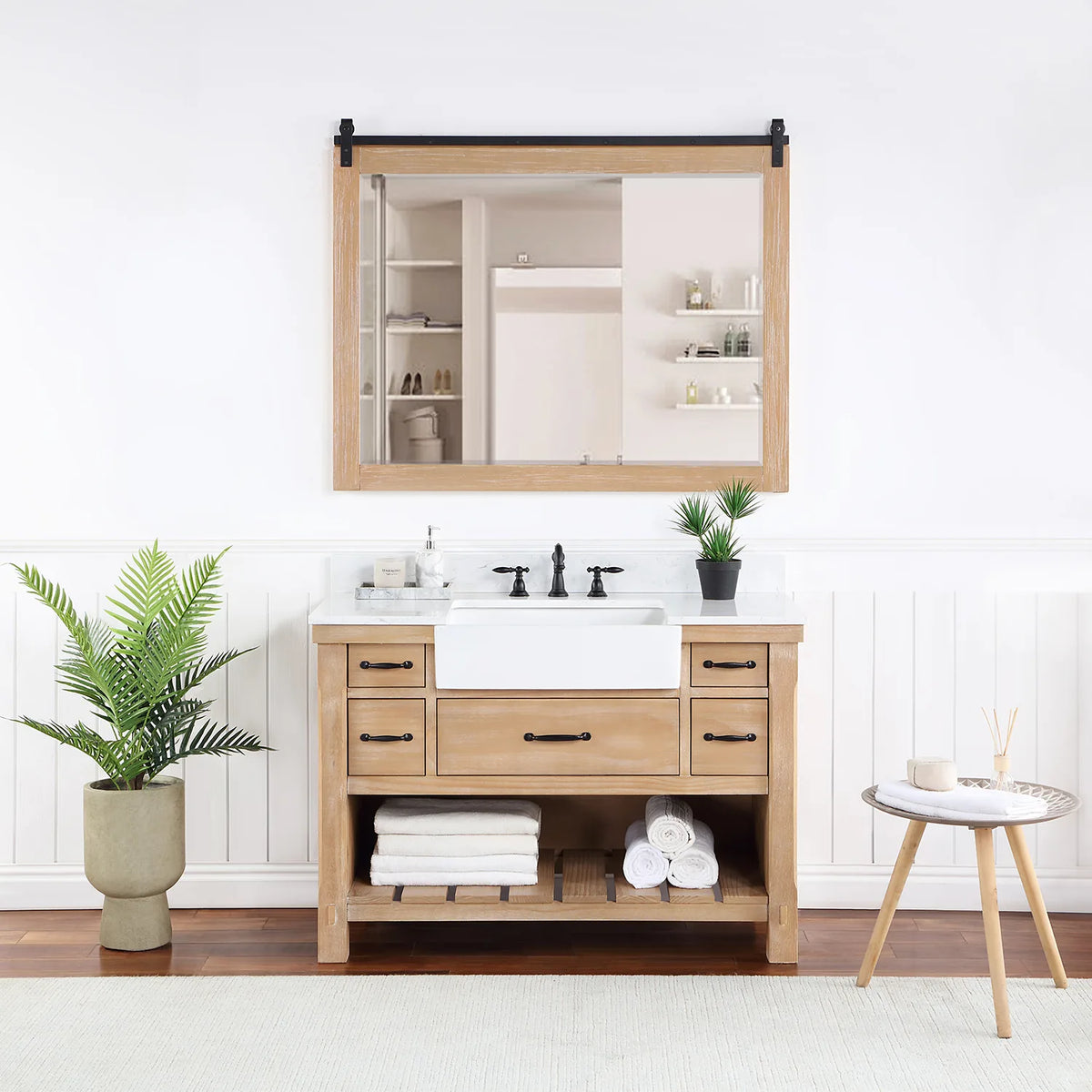 Rectangular mirror with sliding-rail hardware hung over the vanity in a styled room