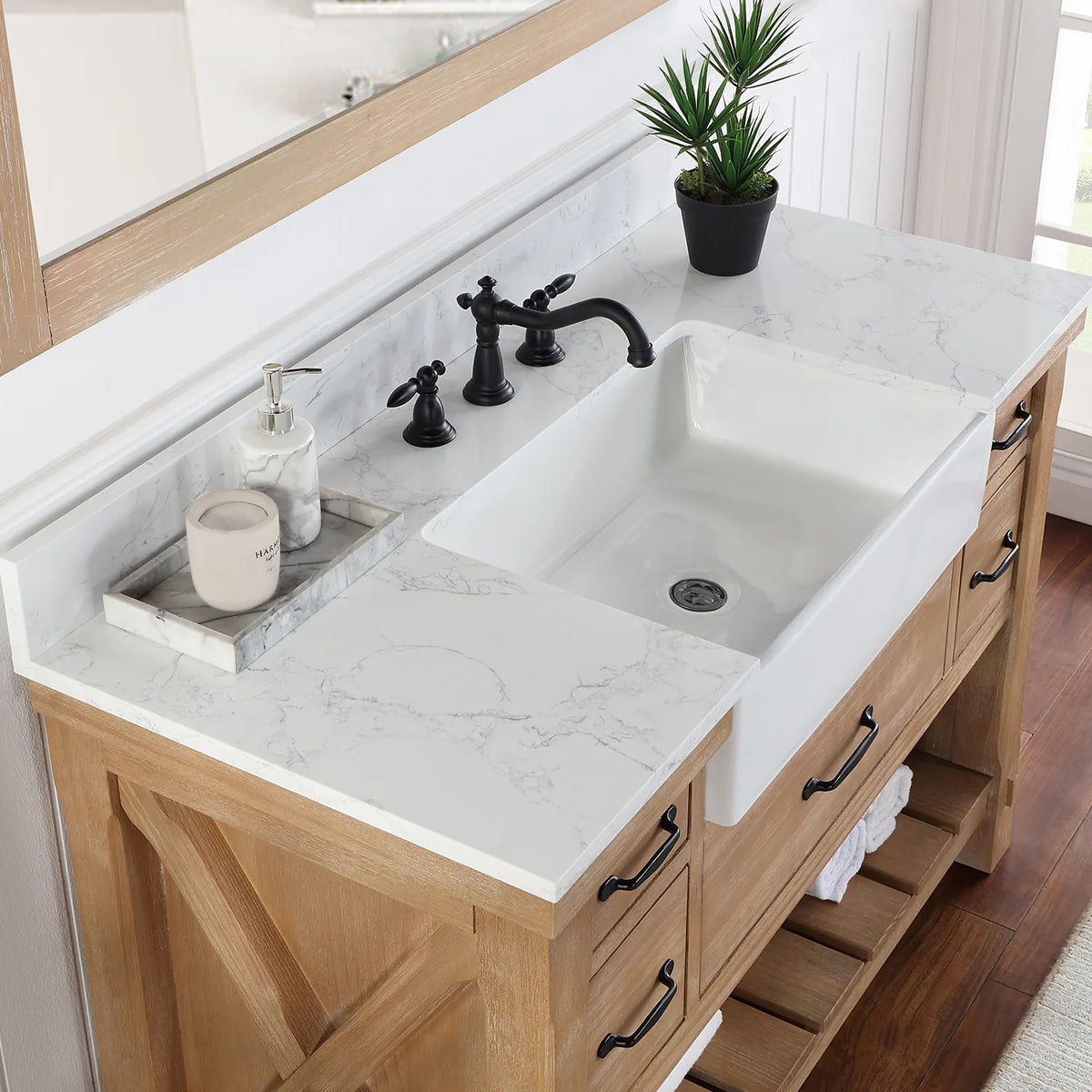 Deep white basin set into the stone top, seen from the side with the faucet