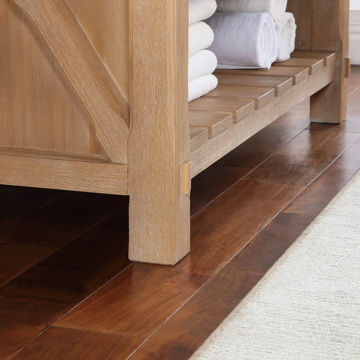 Lower corner showing the leg, crossed brace and slatted open shelving