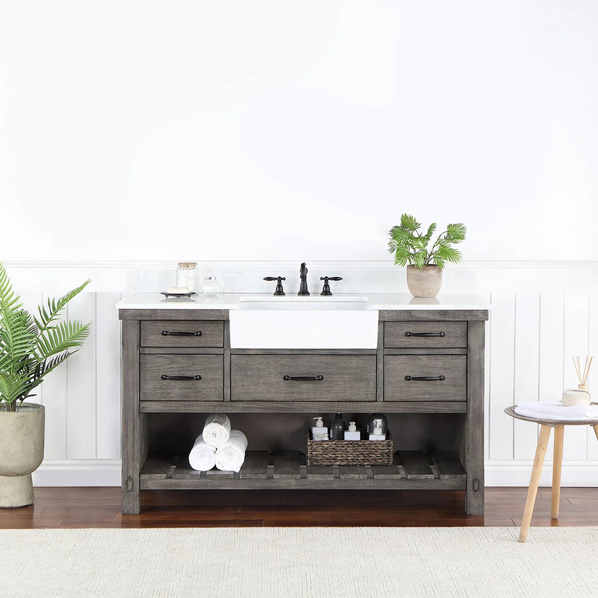 Bathroom setting with white paneled wall, fern and side table beside the vanity
