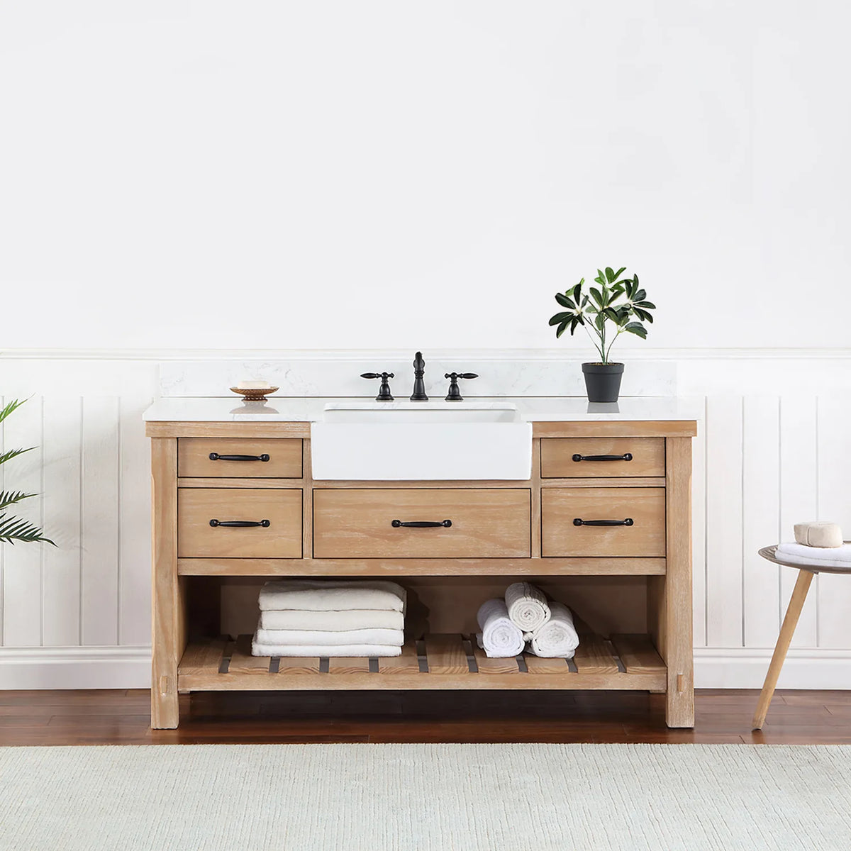 Bathroom setting with white paneled wall, fern and side table beside the vanity