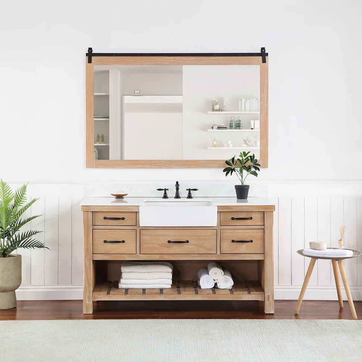 Rectangular mirror with sliding-rail hardware hung over the vanity in a styled room