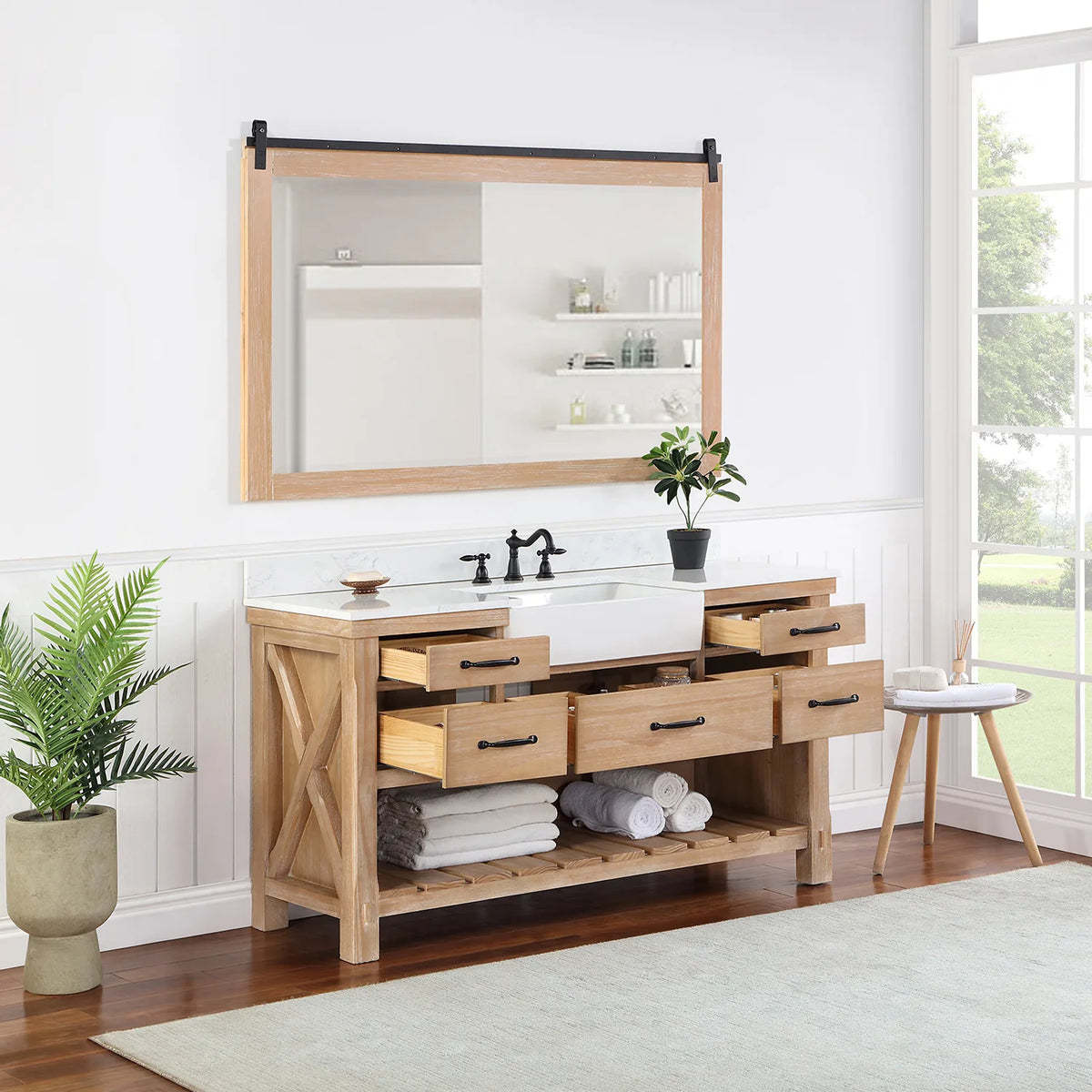 Mirror above the Weathered Pine vanity while the center and side drawers stand open
