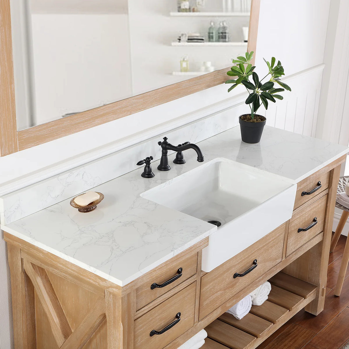 Deep white basin set into the stone top, seen from the side with the faucet