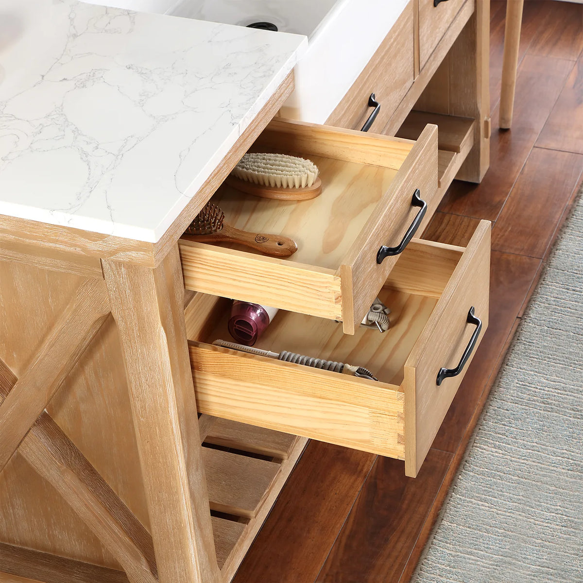 Small drawers pulled open, wood interiors holding brushes and bathroom items