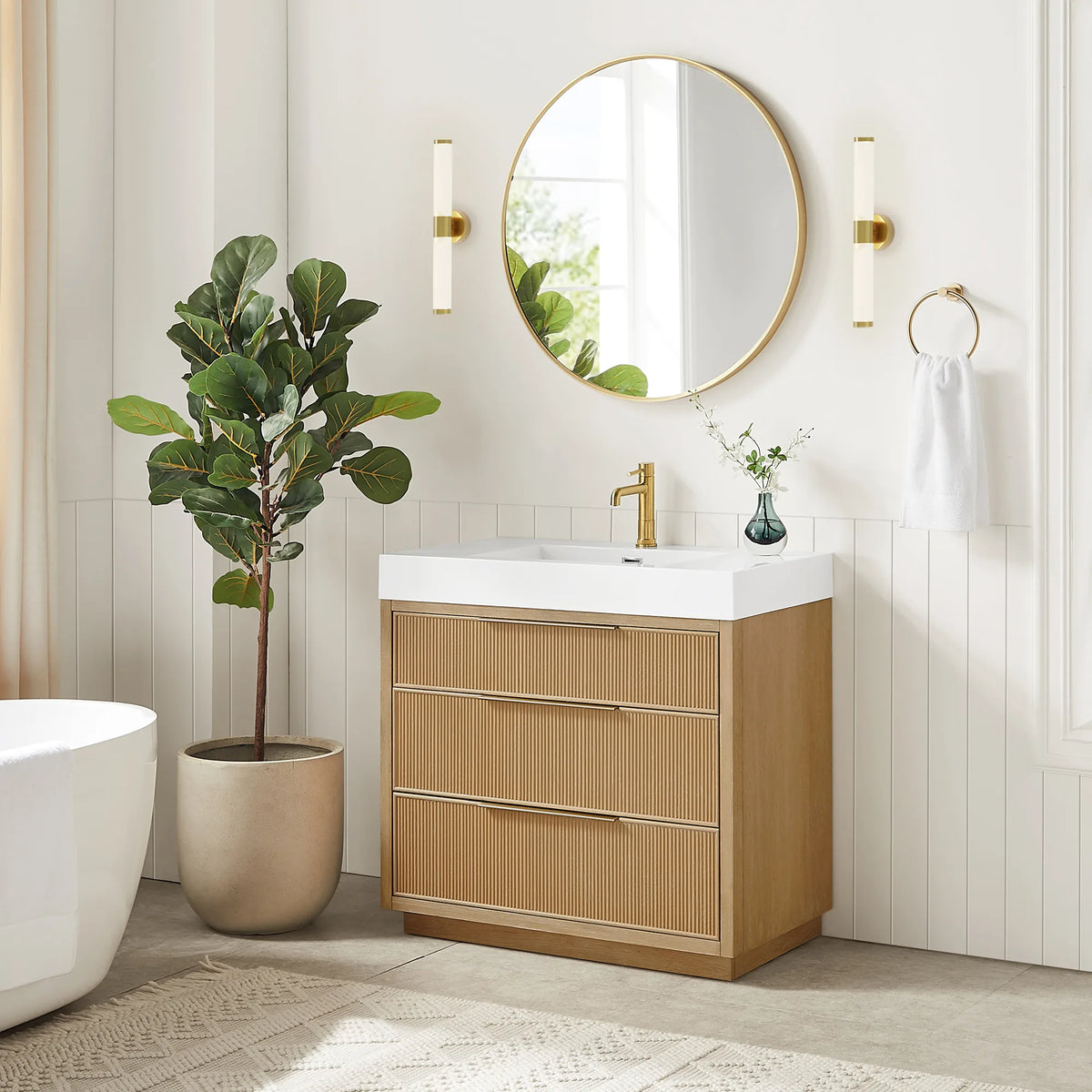 Bathroom scene with the 36-inch Washed Ash Grey vanity under a circular gold mirror, wall sconces beside it and a tub