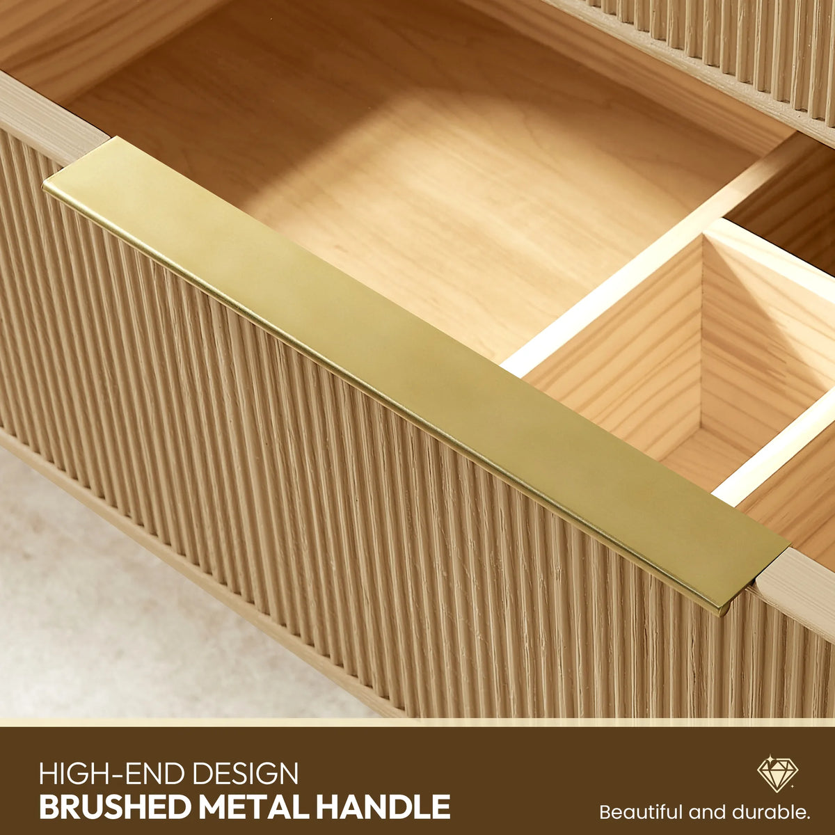 Slim flat metal handle in a gold tone, fitted to a ribbed drawer front, in close detail