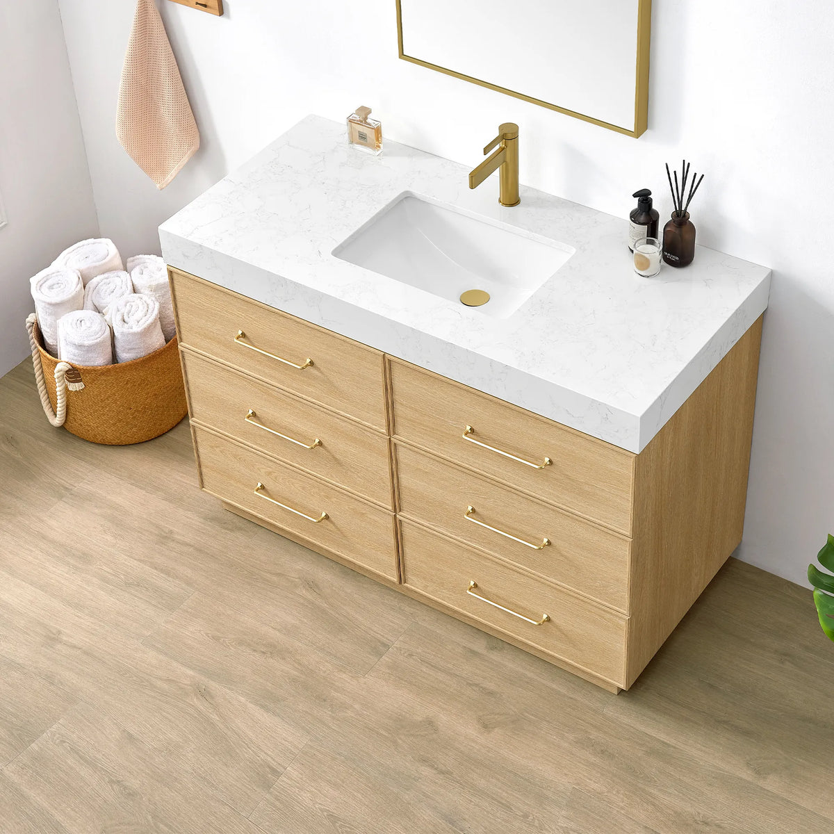 Angled close-up of the Dark Oak vanity with its undermount sink, brushed gold handles and rolled towels