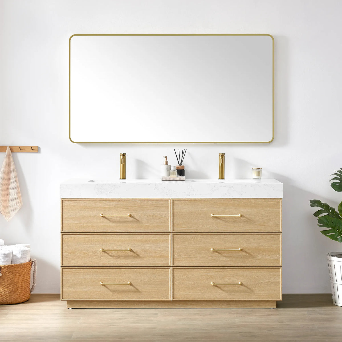 Dark Oak vanity and matching rounded-rectangle mirror with a slim gold frame, styled with towels and a plant