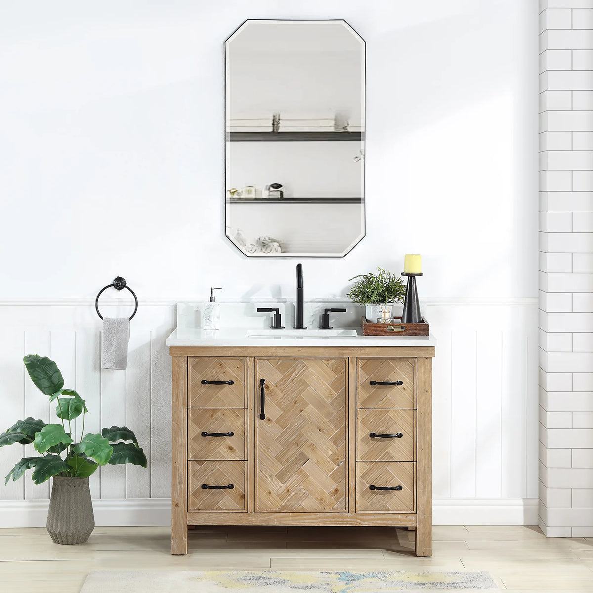 42 inch wood vanity with white top in a bright white-tiled bathroom, octagon mirror on the wall