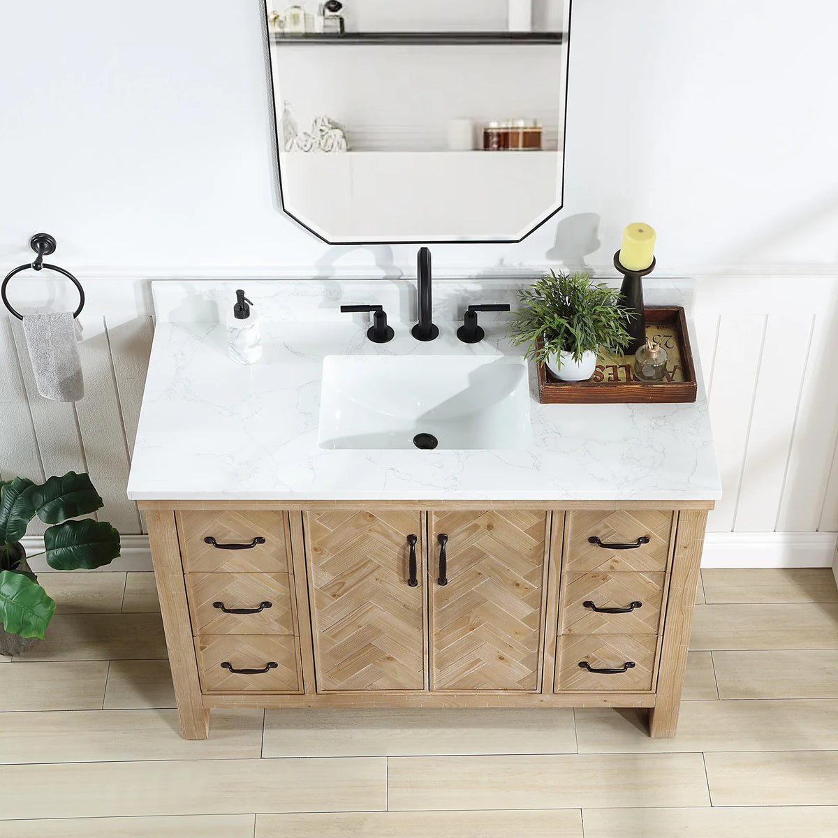 Wide view of the 48 inch vanity with hand-spliced doors and black pulls, tray and plant on the top