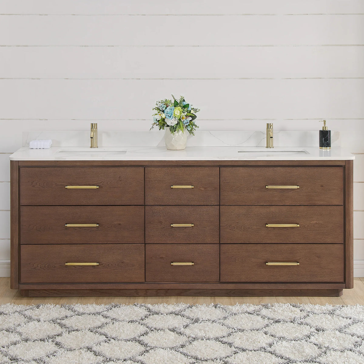 Front view of an 84 inch double vanity in Aged Dark Brown Oak, styled in a shiplap bathroom with brushed gold hardware