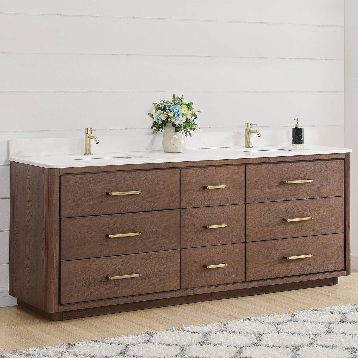 Angled room view of an 84 inch double vanity in Aged Dark Brown Oak with brushed gold pulls
