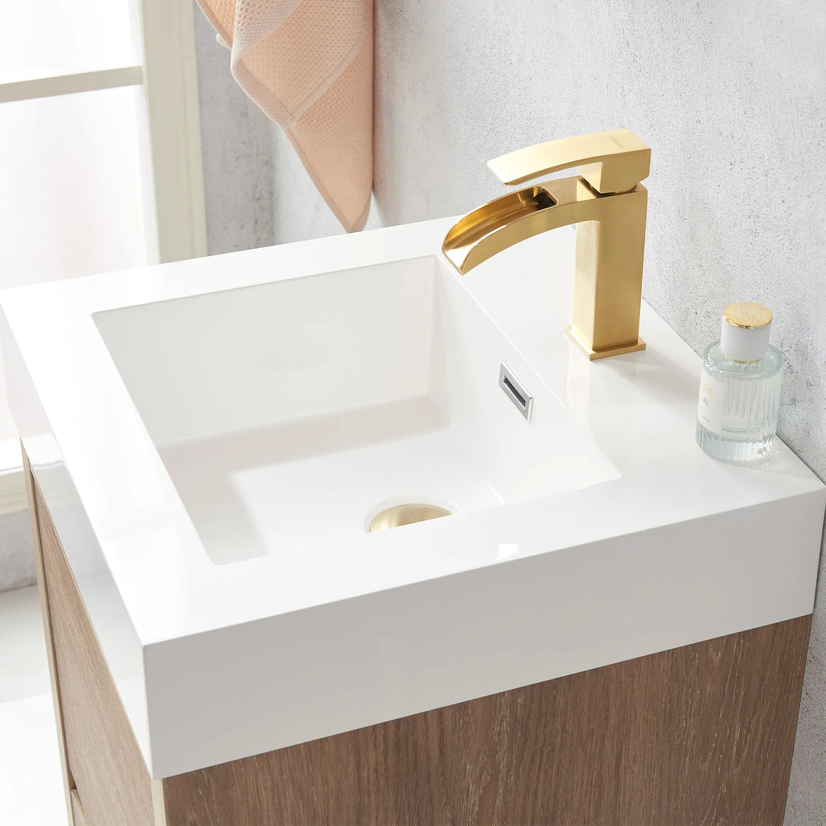 Top-down detail of the integrated white sink and drain, small bottle at the rim