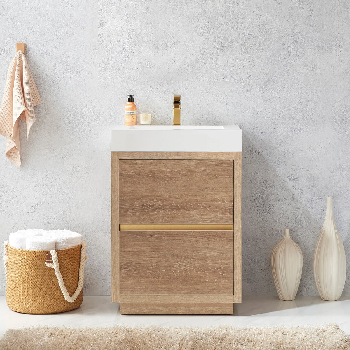 Close front view of the vanity, amber soap bottle on the top, towel basket at left