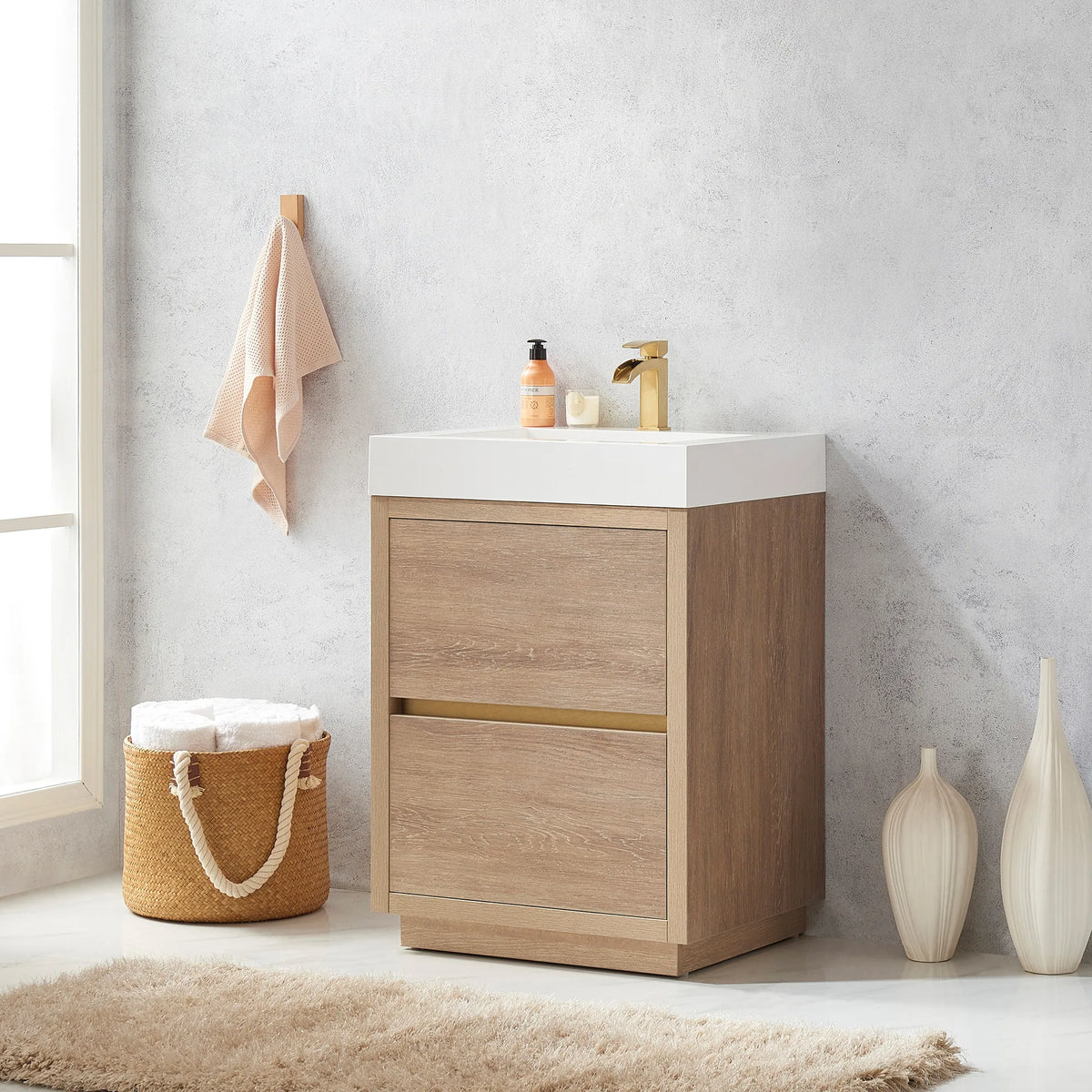 Angled view of the 24 inch vanity with towel hook, rug and white vases
