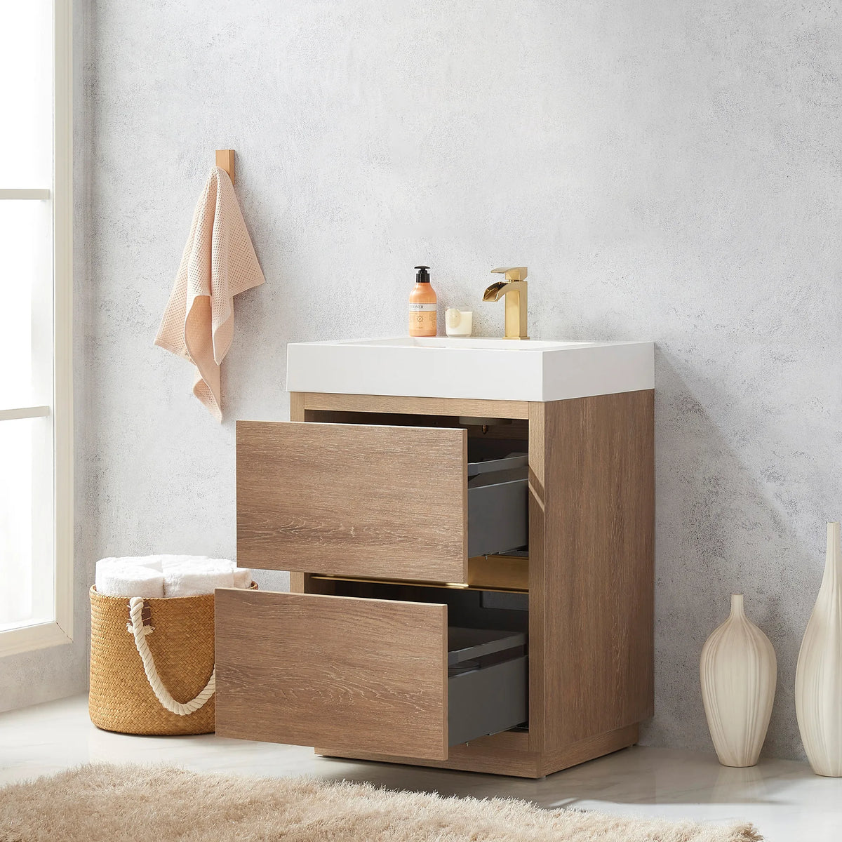 Vanity with drawers pulled open showing gray drawer interiors, basket of towels at left