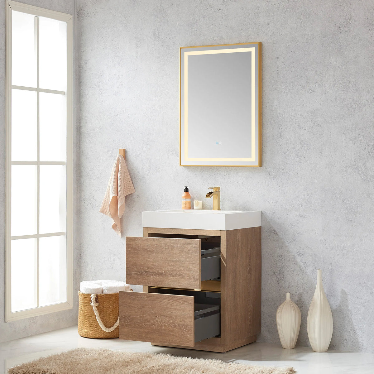 Vanity with mirror above and drawers open, towel basket and rug nearby