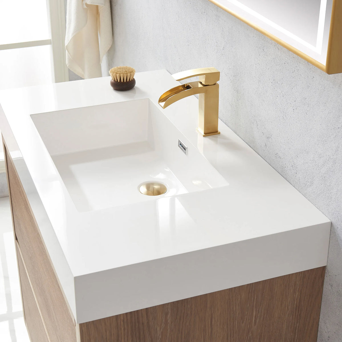 Detail of the white integrated sink with drain and brush, mirror frame in the corner
