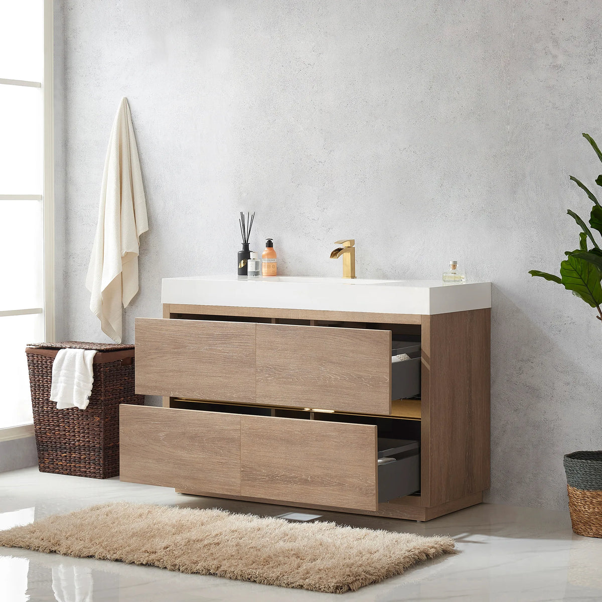 Vanity with drawers open, gray interiors visible, wicker hamper and rug beside it