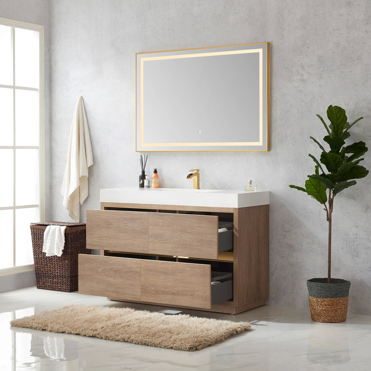 Wide room view of the 48 inch vanity with drawers open, mirror above, hamper, plant and rug