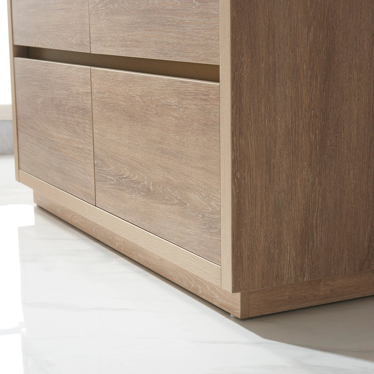 Close-up of the oak front panels and plinth, low angle, white tile floor