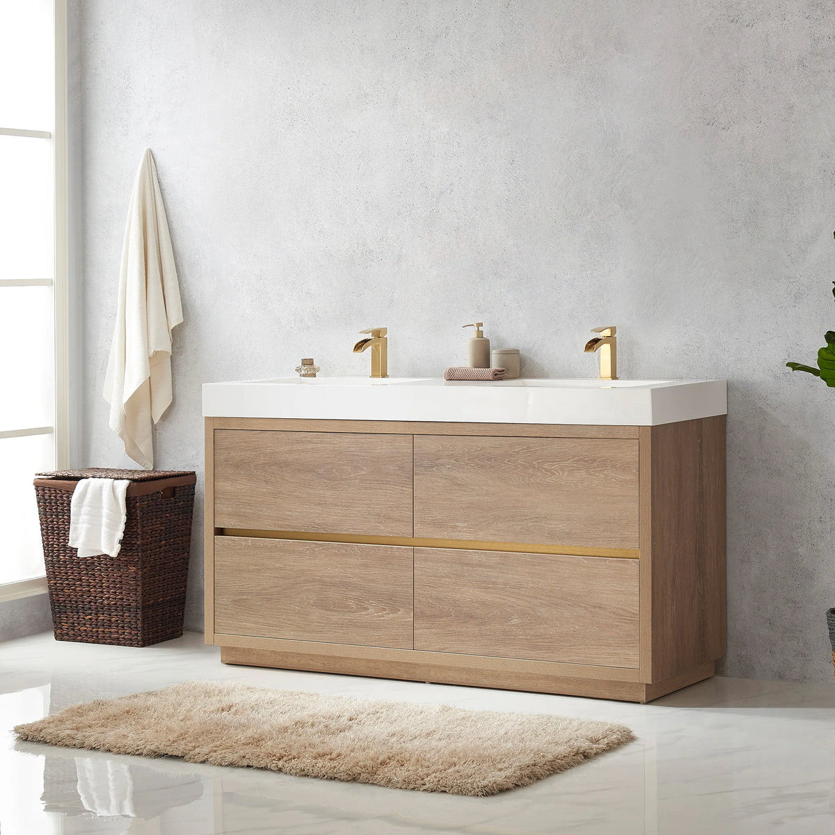 Angled view of the 60 inch double vanity with towel, hamper, plant and rug