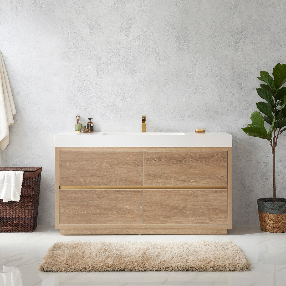 Medium shot of the vanity with toiletries on top, towel hamper at left, plant at right