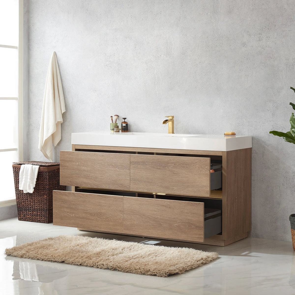 Oak cabinet with drawers extended, gray drawer interiors visible, plus a hamper and a rug in the room