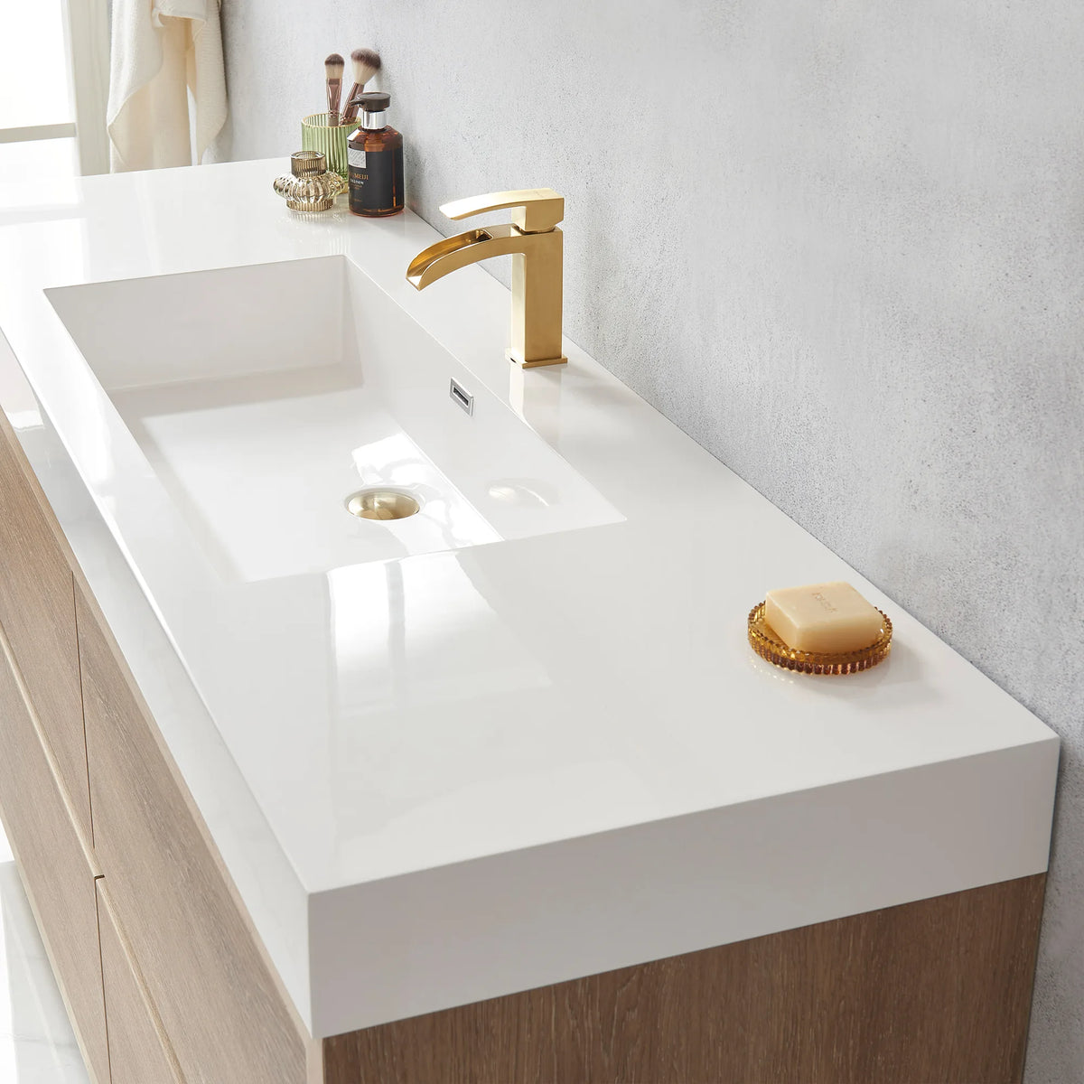 Close-up of the white integrated sink with drain and soap dish on the vanity top